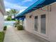 Patio features a blue awning and leads to the home's french doors at 632 Delgado Ave, The Villages, FL 32159