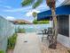 Outdoor pool with lounge seating has a blue canopy offering shade in the yard at 632 Delgado Ave, The Villages, FL 32159