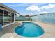 Backyard swimming pool has a painted fence and space for outdoor seating at 632 Delgado Ave, The Villages, FL 32159