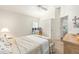 Bright bedroom with a closet, a computer desk, and an open doorway to the bathroom at 857 Enisgrove Way, The Villages, FL 32163