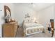 Cozy bedroom featuring a full-sized bed with a floral quilt and coordinated decor at 857 Enisgrove Way, The Villages, FL 32163