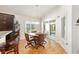 Bright dining area features hardwood floors, backyard view, and seating for four at 857 Enisgrove Way, The Villages, FL 32163