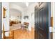 Inviting foyer with wood floors, an arched doorway, and a glimpse into the living spaces at 857 Enisgrove Way, The Villages, FL 32163