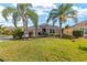 Charming single-story home with lush green lawn, landscaping, and a two-car garage at 857 Enisgrove Way, The Villages, FL 32163