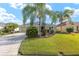 Attractive single-story home with a well-manicured lawn, landscaping, and a two-car garage at 857 Enisgrove Way, The Villages, FL 32163