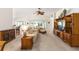 Spacious living room with a comfortable seating area, large windows, and access to the outdoor patio at 857 Enisgrove Way, The Villages, FL 32163