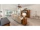 Open living room with a plush sofa, built-in entertainment center, and sliding glass doors to the patio at 857 Enisgrove Way, The Villages, FL 32163