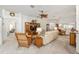 Bright living space featuring a sofa, decorative shelving, and an open layout perfect for entertaining at 857 Enisgrove Way, The Villages, FL 32163