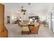Expansive living area showing seating and transitions to the kitchen and dining spaces at 857 Enisgrove Way, The Villages, FL 32163
