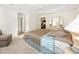 Relaxing bedroom featuring a tray ceiling, neutral walls, and carpeted floors at 857 Enisgrove Way, The Villages, FL 32163