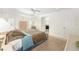 Comfortable bedroom boasting a tray ceiling, ceiling fan, and ensuite bathroom access at 857 Enisgrove Way, The Villages, FL 32163