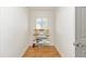 Bright pantry features wood floors, three shelves and a window letting in natural light at 857 Enisgrove Way, The Villages, FL 32163
