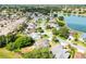An aerial view of a lakeside community with homes near the lake at 917 Camino Del Rey Dr, The Villages, FL 32159