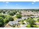 Aerial view of a suburban neighborhood with tree-lined streets and meticulously maintained landscaping at 917 Camino Del Rey Dr, The Villages, FL 32159