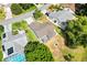 Aerial view of a home with a screened lanai surrounded by lush green landscaping at 917 Camino Del Rey Dr, The Villages, FL 32159