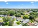 An aerial view of a suburban neighborhood featuring lush green trees and well-maintained homes at 917 Camino Del Rey Dr, The Villages, FL 32159
