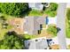 Aerial view of a home featuring a screened lanai and well-maintained landscaping at 917 Camino Del Rey Dr, The Villages, FL 32159