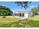Well-maintained backyard with a patio, screened lanai, and lush green lawn at 917 Camino Del Rey Dr, The Villages, FL 32159