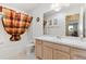 Bathroom with a large mirror, shower-tub combo, and neutral decor at 917 Camino Del Rey Dr, The Villages, FL 32159