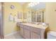 Bathroom featuring a walk-in shower, vanity with mirror, and decorated walls at 917 Camino Del Rey Dr, The Villages, FL 32159