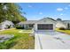 Charming home with a well-manicured lawn, screened garage, and inviting curb appeal at 917 Camino Del Rey Dr, The Villages, FL 32159