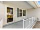 Inviting front porch featuring a glass door, decorative railing, and scenic neighborhood views at 917 Camino Del Rey Dr, The Villages, FL 32159