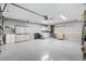 Spacious garage with ample storage space, laundry area, and a ceiling fan at 917 Camino Del Rey Dr, The Villages, FL 32159