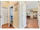 Hallway featuring two closets and access to living room at 917 Camino Del Rey Dr, The Villages, FL 32159