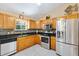 Bright kitchen features stainless steel appliances, granite countertops and beautiful mosaic tile backsplash at 917 Camino Del Rey Dr, The Villages, FL 32159