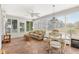 Bright sunroom featuring tile flooring, comfortable seating, and ample windows at 917 Camino Del Rey Dr, The Villages, FL 32159
