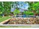 Home exterior view featuring a custom pool, lush landscaping, and serene waterfront views, creating an inviting backyard oasis at 9642 Bear Lake Rd, Apopka, FL 32703