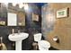 Powder room featuring unique blue and tan mosaic tile and pedestal sink at 9642 Bear Lake Rd, Apopka, FL 32703