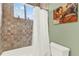 Bathroom showcasing tiled walls, tub, shower, and art at 9642 Bear Lake Rd, Apopka, FL 32703