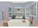 Soaking tub beneath a bay window in a soothing blue bathroom at 9642 Bear Lake Rd, Apopka, FL 32703