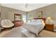 Bright bedroom with a large bed, wooden dresser, and natural light at 9642 Bear Lake Rd, Apopka, FL 32703