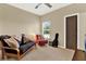 Neutral bedroom with a ceiling fan, large window and comfortable futon at 9642 Bear Lake Rd, Apopka, FL 32703