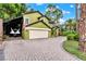 Two story home with a brick driveway, a two car garage, and extra parking at 9642 Bear Lake Rd, Apopka, FL 32703