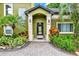 Stunning front door with stone pillars and tropical landscaping at 9642 Bear Lake Rd, Apopka, FL 32703