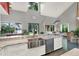 Spacious kitchen features a stainless steel farm sink, marble counters, and ample counter space with a garden view at 9642 Bear Lake Rd, Apopka, FL 32703