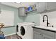 Functional laundry room with modern washer, dryer, and sink at 9642 Bear Lake Rd, Apopka, FL 32703
