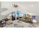 Stylish living room with a vaulted ceiling, unique decor, and comfortable seating at 9642 Bear Lake Rd, Apopka, FL 32703