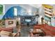 Inviting living room featuring a fireplace, surfboard decor, and vaulted ceilings at 9642 Bear Lake Rd, Apopka, FL 32703