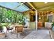 Inviting outdoor kitchen and patio area, perfect for entertaining and relaxing with seating and decorative mural art at 9642 Bear Lake Rd, Apopka, FL 32703