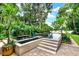 Backyard pool with stone accents, lush landscaping, and a serene setting for relaxation and recreation by the waterfront at 9642 Bear Lake Rd, Apopka, FL 32703