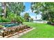 Backyard showcases a beautiful custom pool, lush greenery, and a tranquil waterfront view, creating a private oasis at 9642 Bear Lake Rd, Apopka, FL 32703