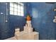 Blue-tiled shower with natural light and convenient built-in shelving at 9642 Bear Lake Rd, Apopka, FL 32703