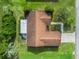 Overhead view of the home with a brown roof, enclosed lanai, and neatly landscaped surroundings at 9757 Se 175Th Pl, Summerfield, FL 34491