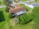 Aerial view of the home showing mature trees, backyard, and enclosed sunroom at 9757 Se 175Th Pl, Summerfield, FL 34491