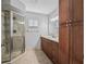 Bathroom features a glass shower, vanity with drawers, and lots of storage at 9757 Se 175Th Pl, Summerfield, FL 34491