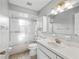 Bathroom with a tub shower, white vanity, and matching cabinet at 9757 Se 175Th Pl, Summerfield, FL 34491